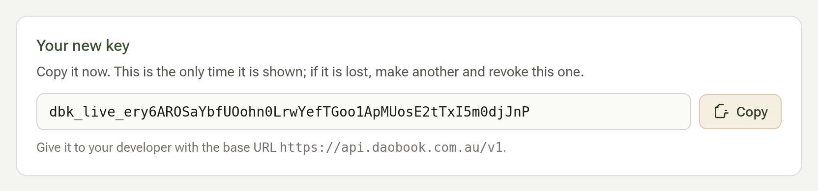 The Your new key box showing the key once, with a Copy button and the base URL for your developer