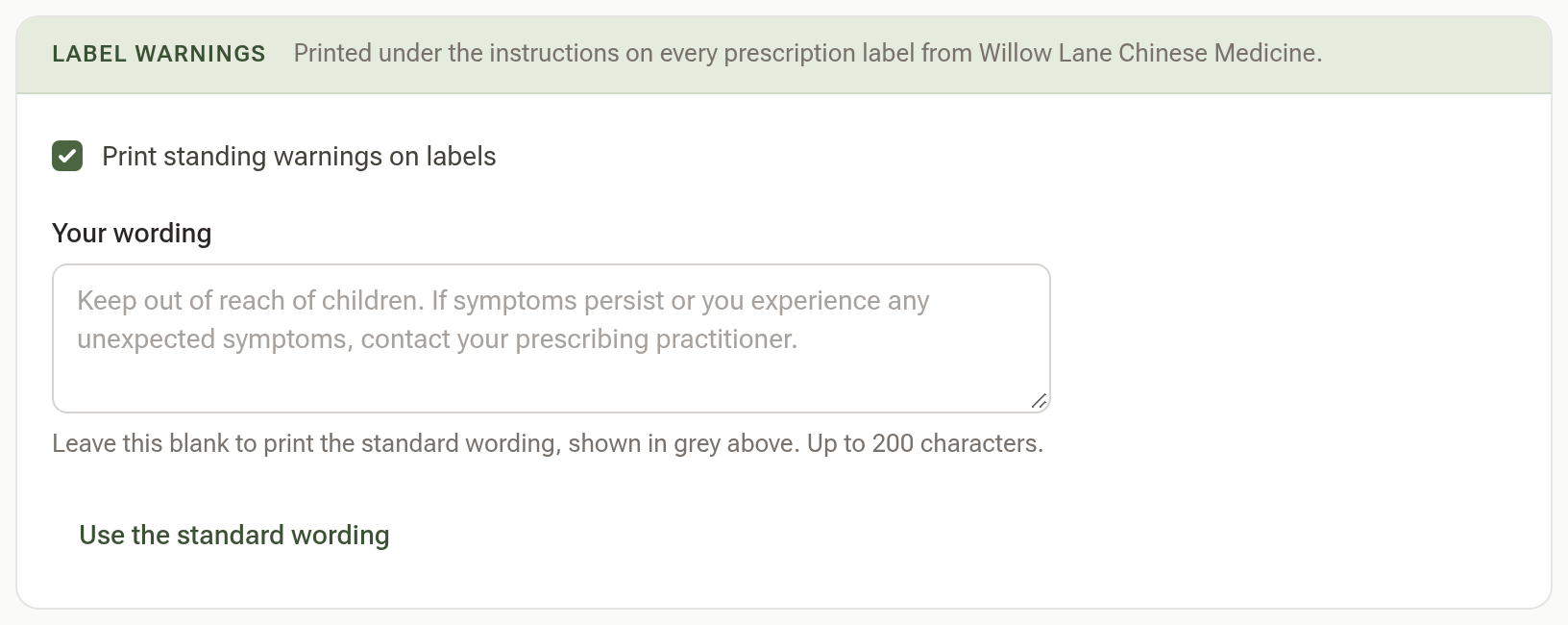 The Label warnings card, with Print standing warnings on labels ticked, a Your wording box showing the standard wording in grey, and a Use the standard wording button